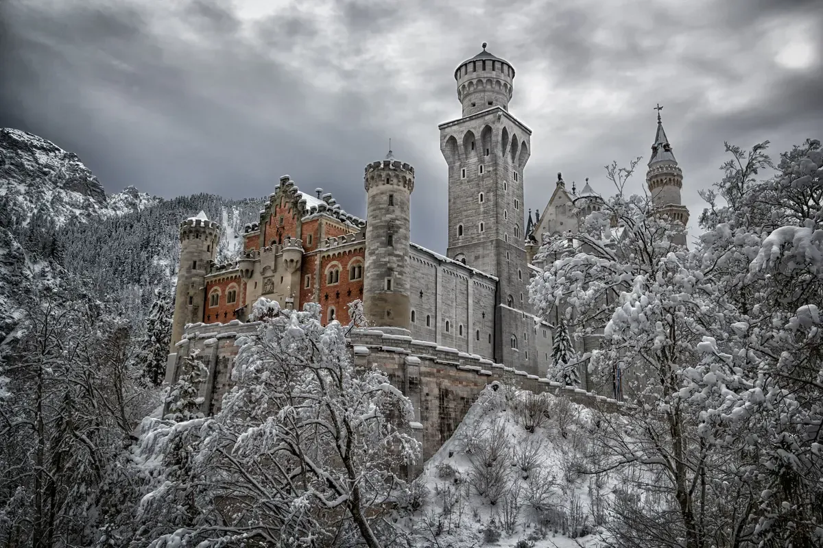Neuschwanstein Castle towers under snow on a winter Neuschwanstein castle tour from Munich, Bavaria