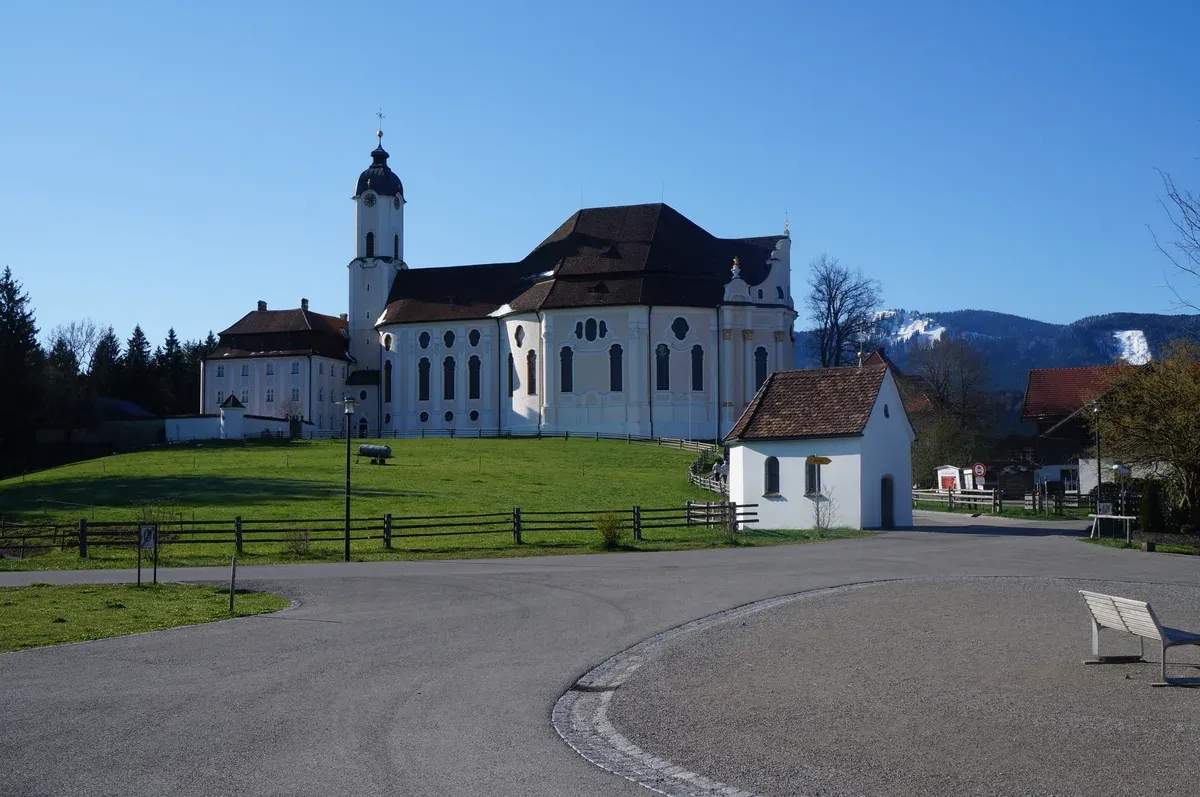 The Wieskirche pilgrimage church with the Alps behind, a stop on a Neuschwanstein small-group tour from Munich, Bavaria